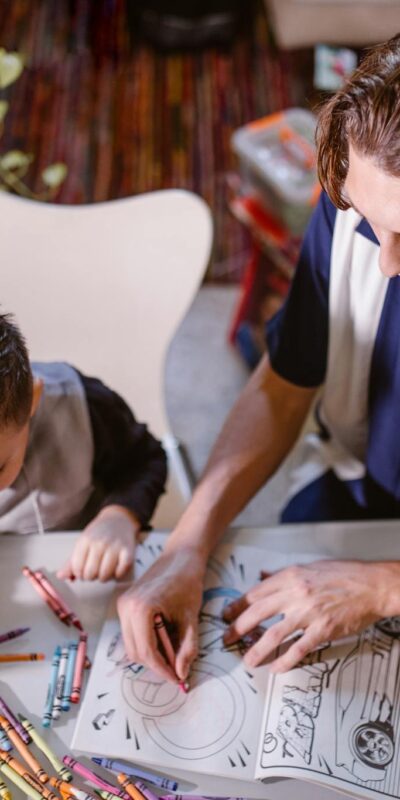 Man in Blue and White Polo Shirt Writing on White Paper